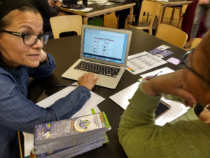 A librarian and a student work on a computer together