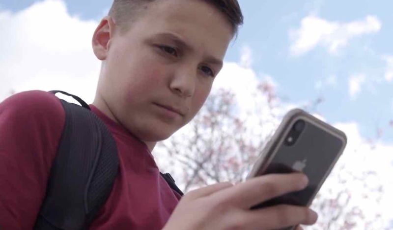 Teenage boy looking at mobile phone