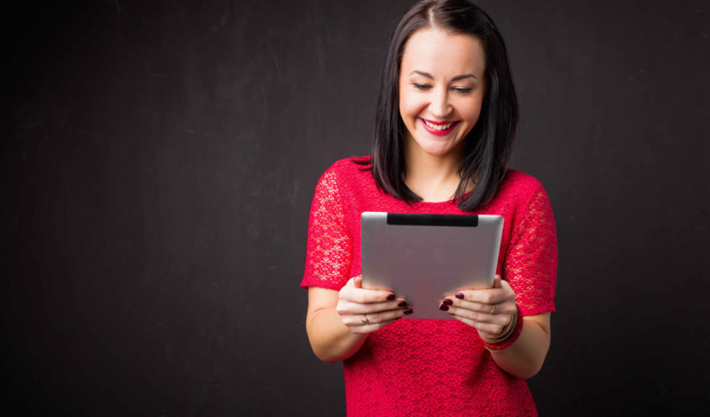 Woman smiling while using ipad