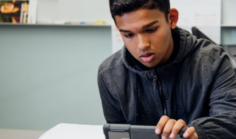male student using iPad
