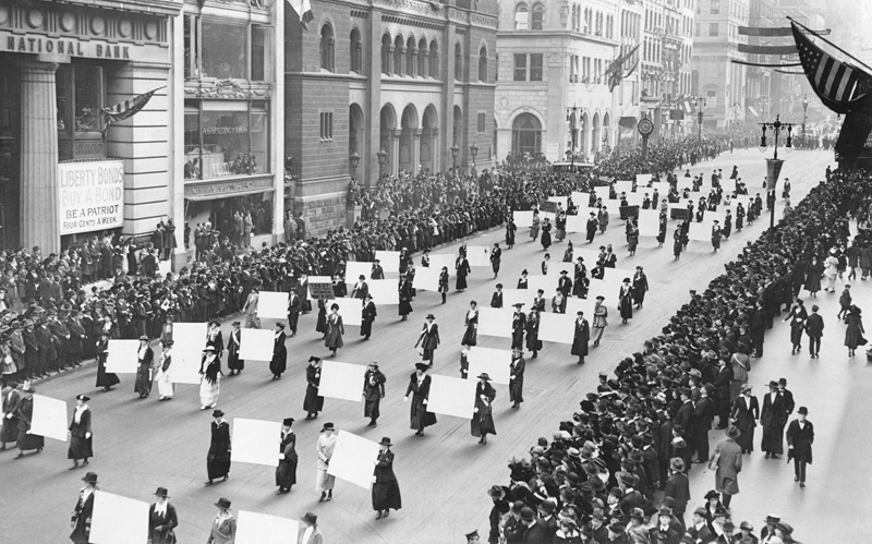 Women suffragists march in New York City in 1917, carrying placards with the signatures of more than a million women. (New York Times archive)