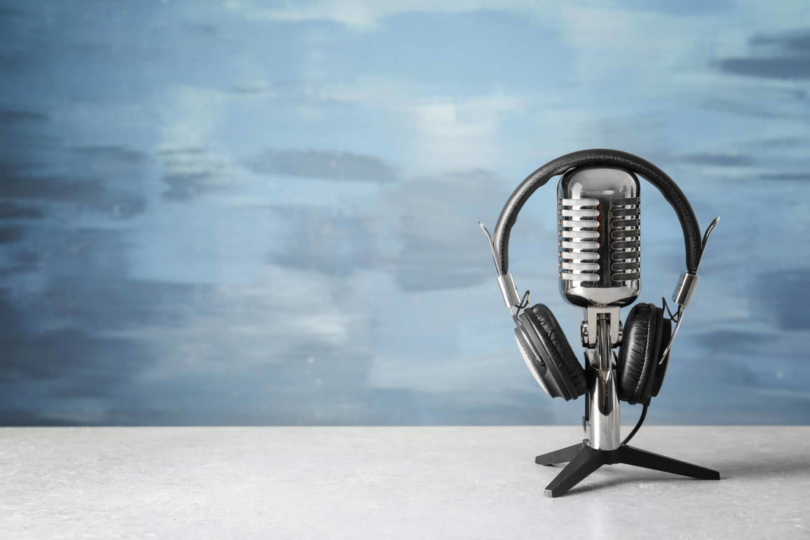 image of microphone on table with headphones on top