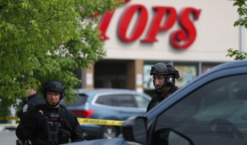 Police secure a perimeter after a shooting at a supermarket, in Buffalo, N.Y