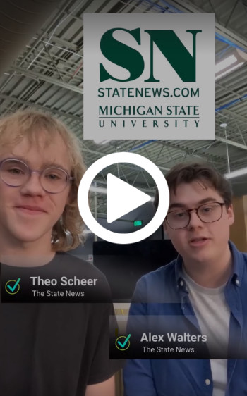 Student journalists Theo Scheer and Alex Walters, who work on The State News newspaper at Michigan State University, are side-by-side with their newsroom in the background.