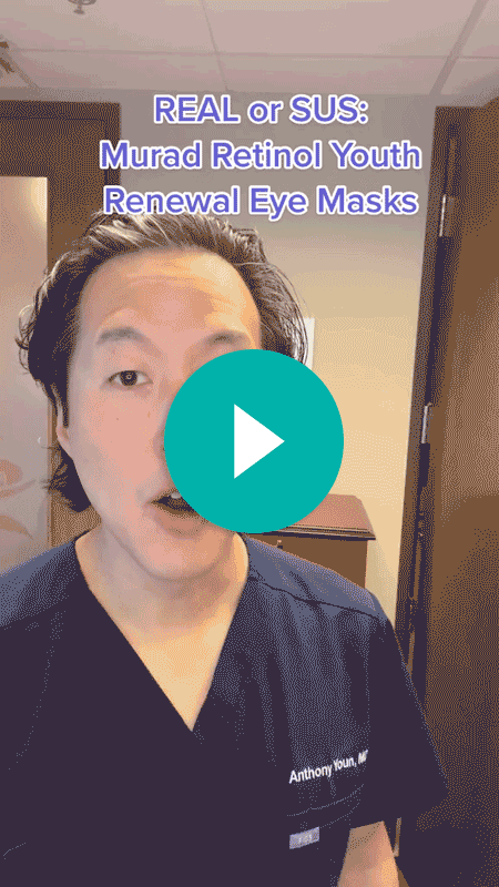 A screenshot of a video shows a man wearing medical scrubs indoors facing the camera and text that says, “REAL or SUS: Murad Retinol Youth Renewal Eye Masks.” A teal play button is over the man’s face.