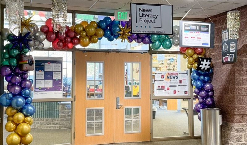 A colorful balloon archway and small chandeliers hang over the doorway to the Crested Butte Community School library.