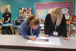 Las Cruces educators Megan Belch and Chelsea Lester participate in a critical observation exercise to vet the legitimacy of an image and its use at a professional learning event.