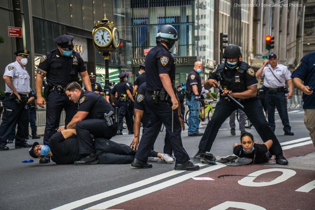 Protesters demonstrating against the death of George Floyd while being restrained by Minneapolis police