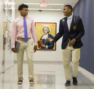 lschs_2 - The News Literacy Project Two high school students walking in school hallway, facing each other while talking