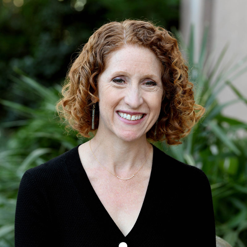 Matea Gold - The News Literacy Project A woman in a black top with curly, chin-length hair smiles directly into the camera.