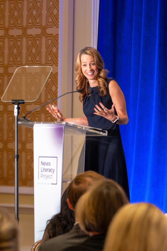 Abby Cox 2 - The News Literacy Project A woman stands at a podium giving a speech.
